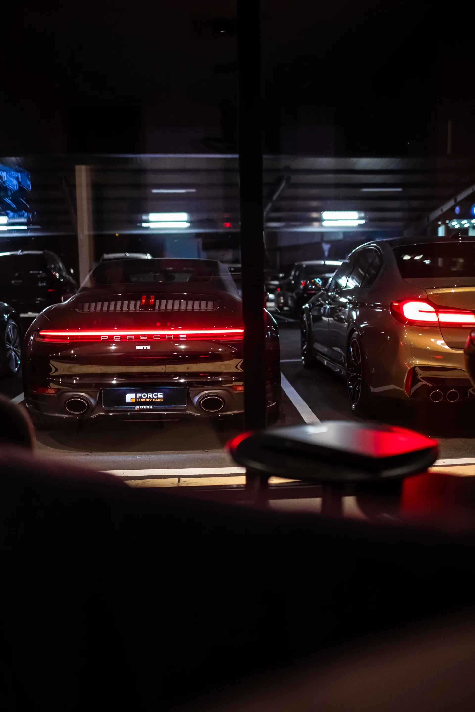 View of cars from inside of Force Luxury Cars office View of cars from inside of Force Luxury Cars office